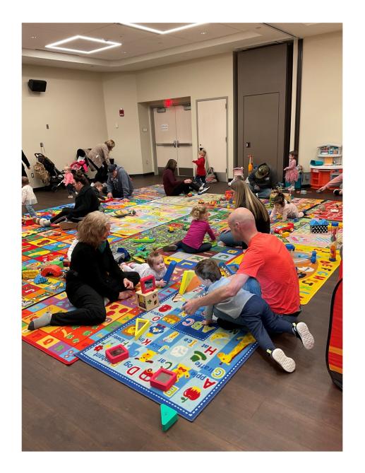 Families playing and interacting in our Winter 2024 Session of 1, 2, 3 Play With Me, our parent/toddler workshop.