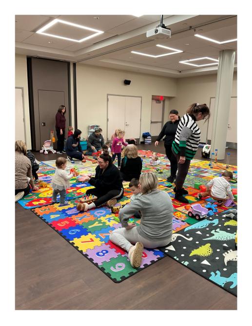 Families playing and interacting in our Winter 2024 Session of 1, 2, 3 Play With Me, our parent/toddler workshop.