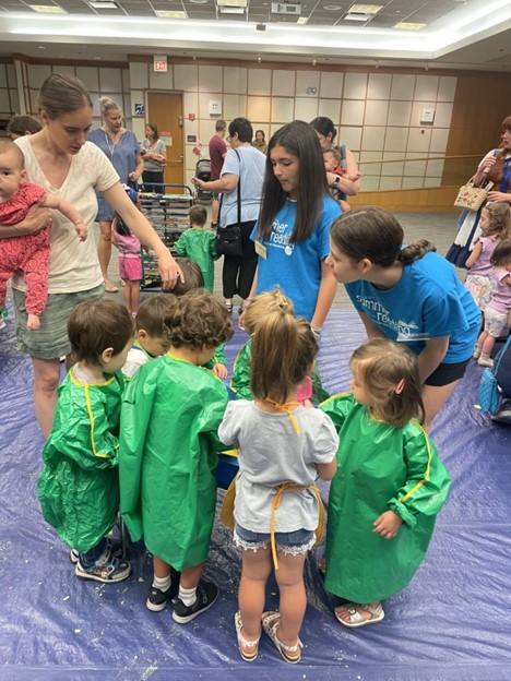 2 and 3 year-olds create process art with guidance from teen volunteers