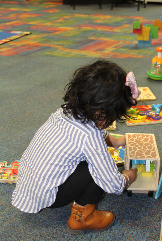 Child playing with early learning manipulatives