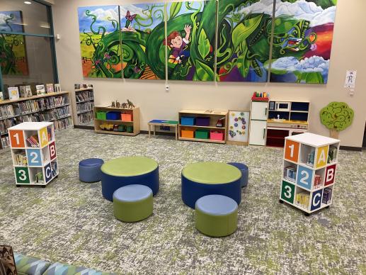Image of a play area with toys and a play kitchen along one wall.