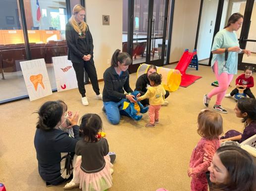 Children playing with Puppet Dragon's Giant Teeth as they learn about their own teeth from Texas Tiny Teeth Pediatric Dentistry