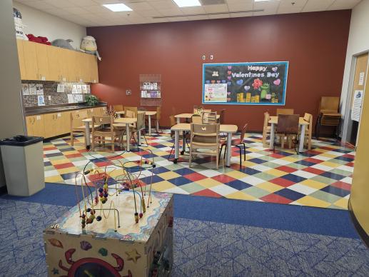 Activity Room where children color, build crafts, and play wooden puzzle games.