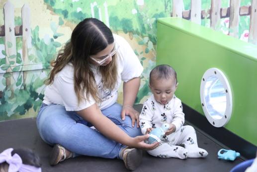 baby and mother playing in a baby garden play space 