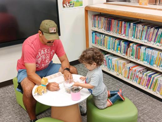 Father and son coloring together