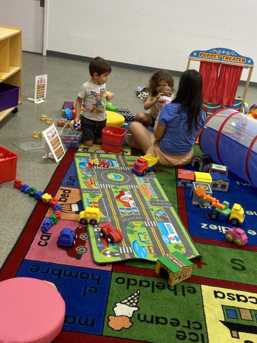 A few of our family place attendees enjoying playing with toys!