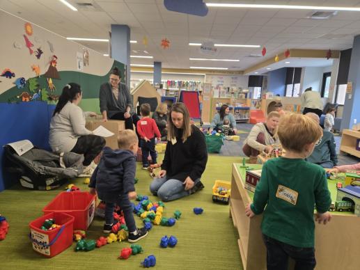 children and caregivers playing with colorful toys