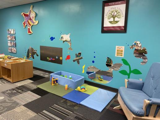 Infant Play Area featuring mirrors, crawling mat, and nursing rocker