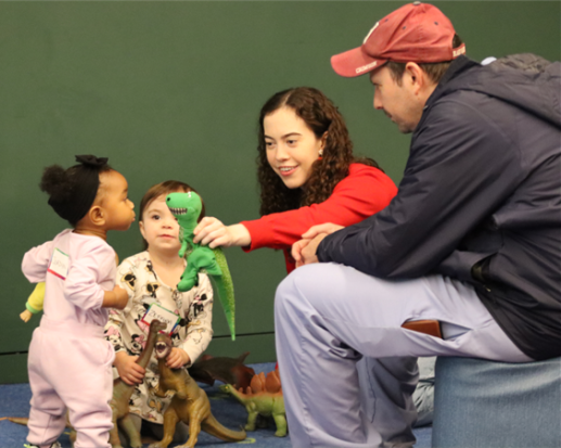 Toddlers and caregivers playing with puppets