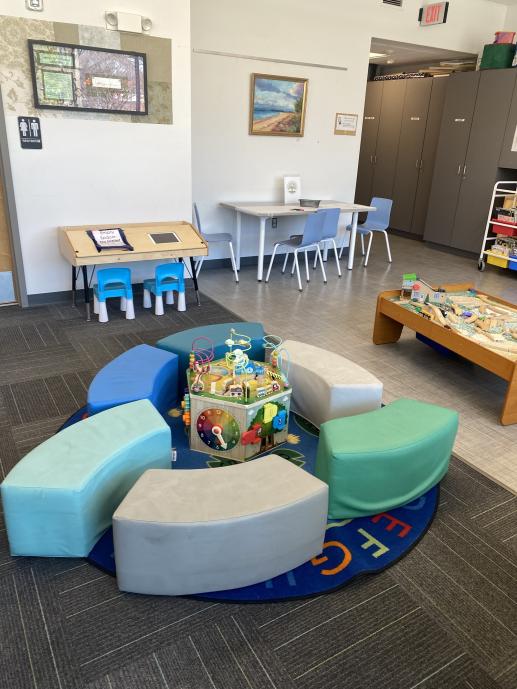 Cheerful play space with busy box and train table.