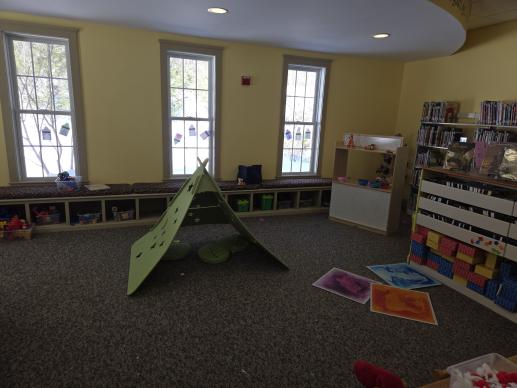 children's library room with a green tent and toys visible